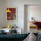 Living room with a dining table and chairs, and a bedroom in the background. Field red – Bold Abstract Canvas Print | Large Luxury Wall Art | Brume Art