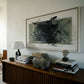 Wooden console table with books, sculptures, and a lamp against a wall with abstract art. Tension 2 – Bold Abstract Canvas Print | Large Luxury Wall Art | Brume Art
