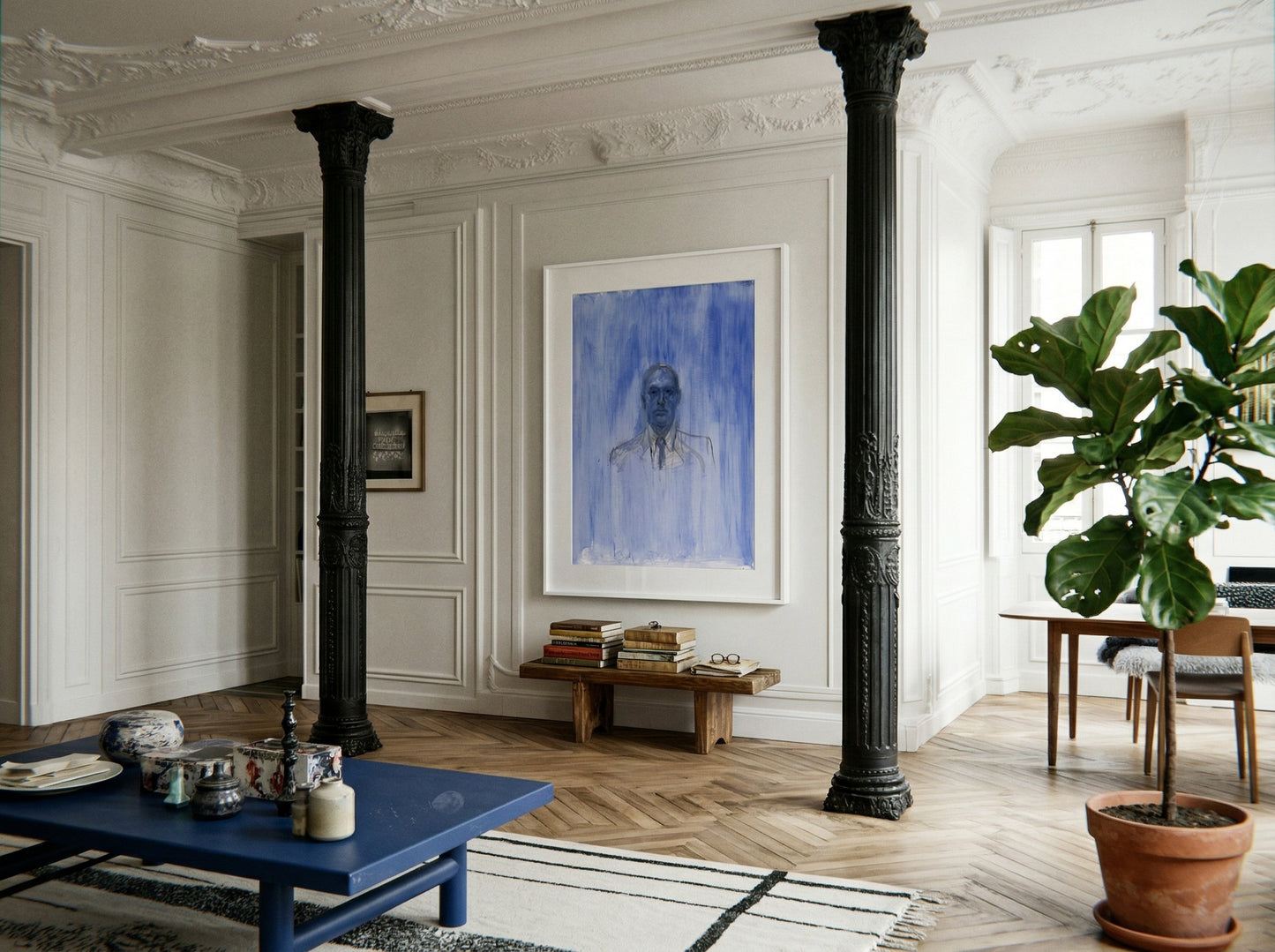 Living room with a blue coffee table, framed portrait, and potted plant. Portrait of a Man – Contemporary Portrait Canvas | Luxury Wall Art | Brume Art | Luxury Wall Decor | Large Canvas Wall Art | Oversized Wall Hanging-Brume art