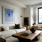 Modern living room with a white sofa, wooden coffee table, and decorative items. Portrait of a Man – Contemporary Portrait Canvas | Luxury Wall Art | Brume Art | Luxury Wall Decor | Large Canvas Wall Art | Oversized Wall Hanging-Brume art