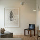 Modern interior with abstract artwork on a wall, chair, and small table. Silhouette Sketch – Figurative Sketch Canvas Print | Luxury Wall Art | Brume Art