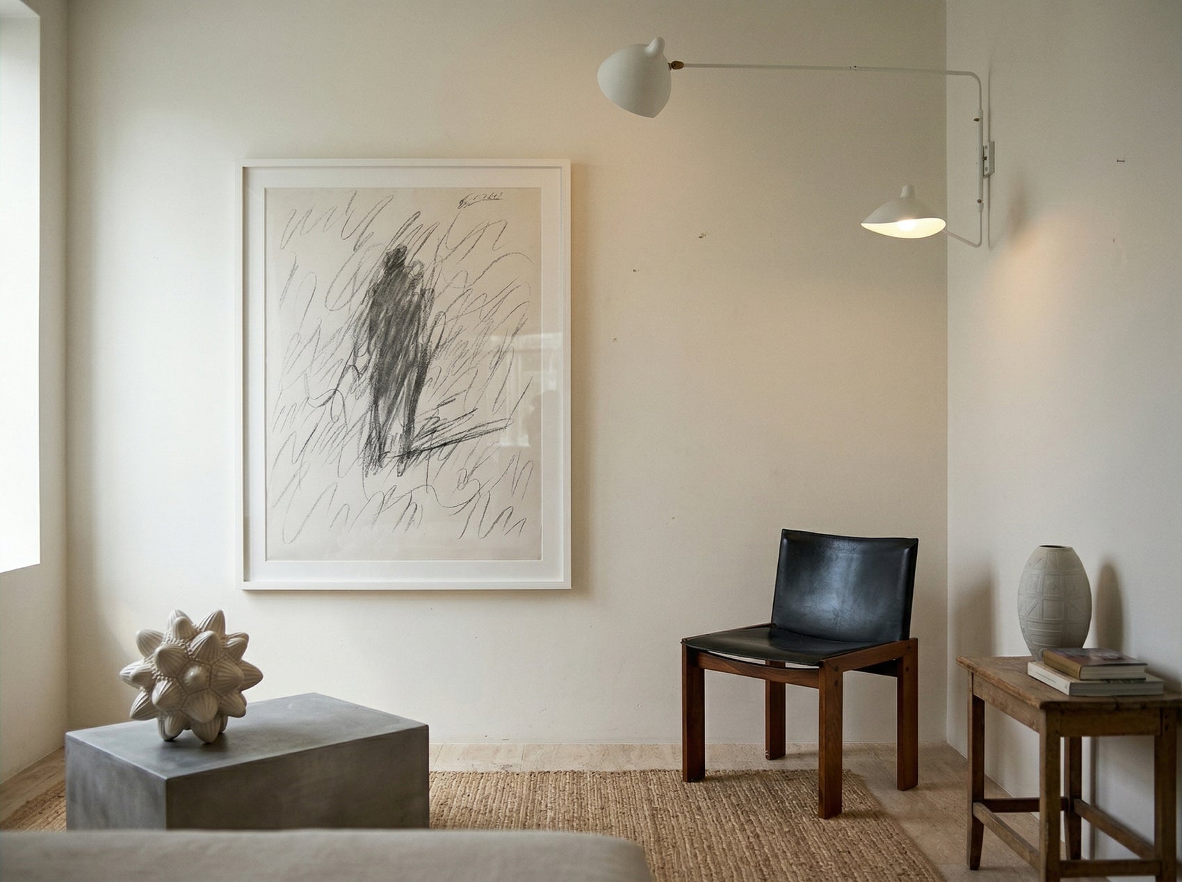 Modern interior with abstract artwork on a wall, chair, and small table. Silhouette Sketch – Figurative Sketch Canvas Print | Luxury Wall Art | Brume Art