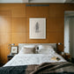 Bedroom with wooden paneling, a bed, and framed artwork on the wall. Silhouette Sketch – Figurative Sketch Canvas Print | Luxury Wall Art | Brume Art