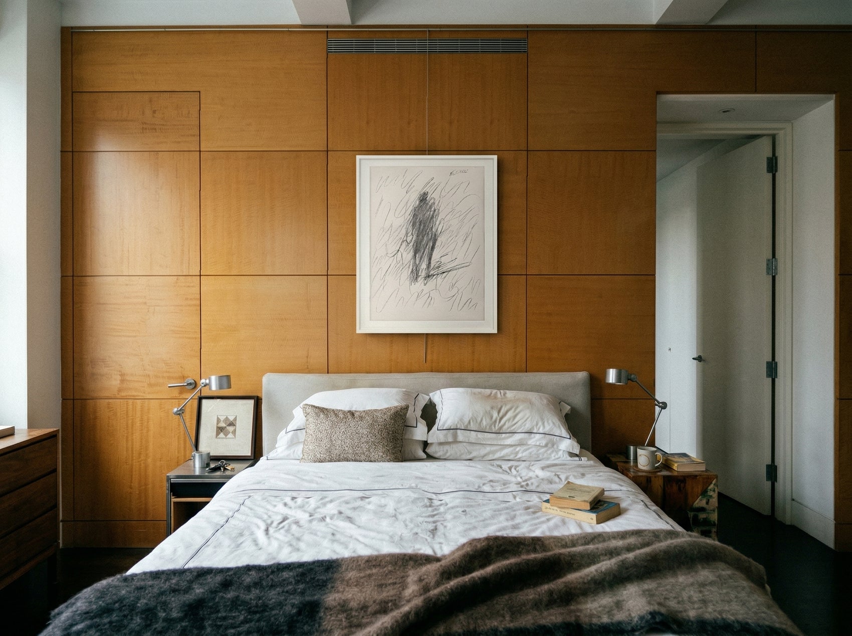 Bedroom with wooden paneling, a bed, and framed artwork on the wall. Silhouette Sketch – Figurative Sketch Canvas Print | Luxury Wall Art | Brume Art