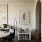 Modern interior with a round table, chairs, books, and artwork on the wall. Silhouette Sketch – Figurative Sketch Canvas Print | Luxury Wall Art | Brume Art