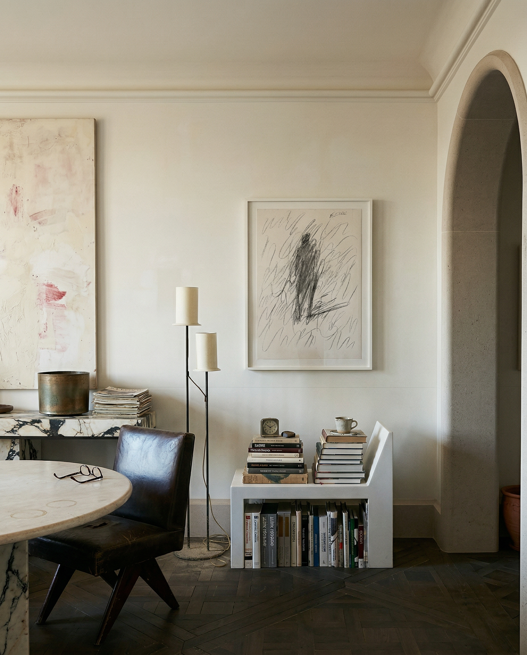 Modern interior with a round table, chairs, books, and artwork on the wall. Silhouette Sketch – Figurative Sketch Canvas Print | Luxury Wall Art | Brume Art