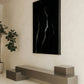Modern interior with a large black abstract painting on a white wall, a gray bench, and a potted plant. Strike 2 – Bold Abstract Canvas Wall Art | Premium Luxury Print | Brume Art