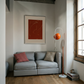 Gray sofa with decorative pillows in a room with a red abstract painting on the wall. Presence 2 – Figurative Abstract Canvas | Premium Wall Art | Brume Art