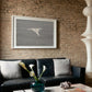 Living room with a black sofa, framed artwork on a brick wall, and decorative items on a coffee table. Thong - Minimalist Abstract Canvas Art | Large Luxury Wall Print | Brume Art