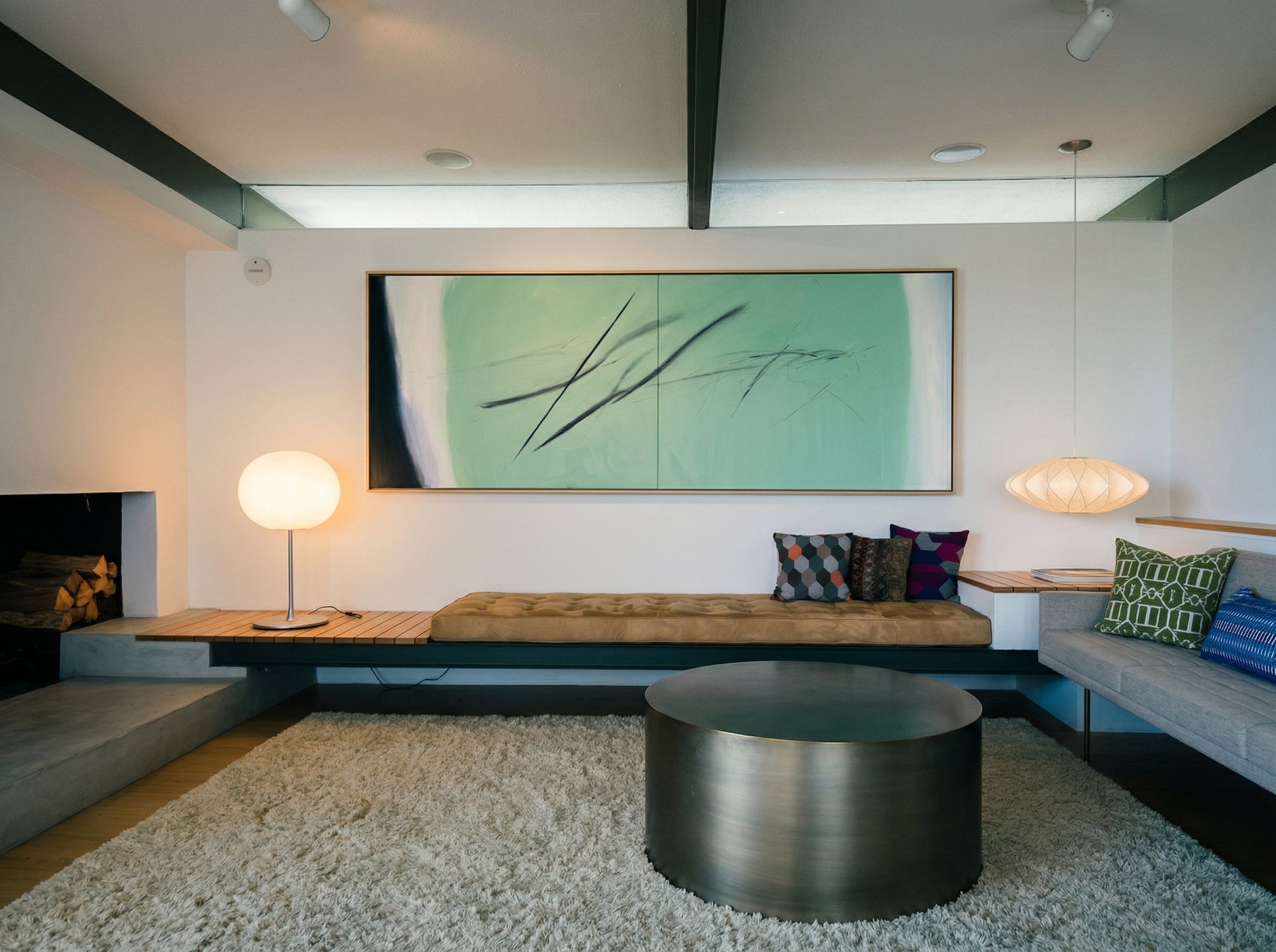 Modern living room with a large abstract painting, round metal table, and comfortable seating. Big battle - Abstract Diptych Canvas Wall Art | Oversized Luxury Print | Brume Art | Luxury Wall Decor | Large Canvas Wall Art | Oversized Wall Hanging-Brume art