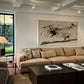 Modern living room with beige sectional sofa, armchair, and abstract art on the wall. Ink – Abstract Ink Canvas Wall Art | Large Premium Print | Brume Art | Luxury Wall Decor | Large Canvas Wall Art | Oversized Wall Hanging-Brume art