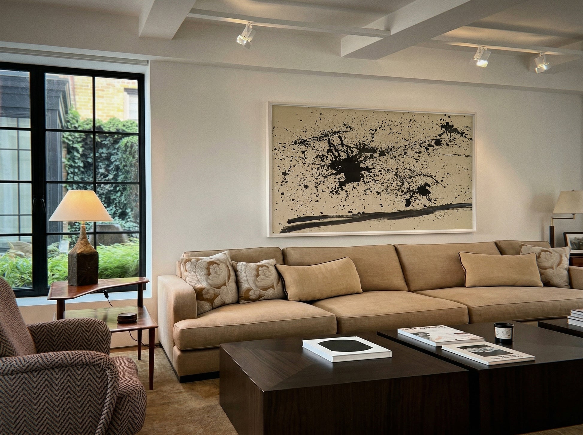 Modern living room with beige sectional sofa, armchair, and abstract art on the wall. Ink – Abstract Ink Canvas Wall Art | Large Premium Print | Brume Art | Luxury Wall Decor | Large Canvas Wall Art | Oversized Wall Hanging-Brume art
