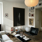 Modern living room with a black leather chair, white sofa, and decorative items. In the black – Bold Abstract Canvas Wall Art | Large Luxury Print | Brume Art