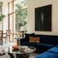 Modern living room with a blue sofa, glass coffee table, and large windows. In the black – Bold Abstract Canvas Wall Art | Large Luxury Print | Brume Art