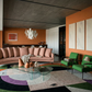 Modern living room with a pink sofa, green chairs, and colorful rug. Black lines 2 – Bold Abstract Canvas Wall Art | Premium Luxury Print | Brume Art| Luxury Wall Decor | Large Canvas Wall Art | Oversized Wall Hanging-Brume art