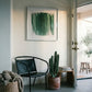 Modern interior with a black chair, potted cactus, and abstract art on a white wall. Field green 3 – Textured Abstract Canvas Art | Premium Luxury Wall Decor | Brume Art