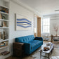 Modern living room with a blue sofa, bookshelf, and abstract painting. Blue Stripes – Abstract Diptych Canvas Art | Large Luxury Wall Print | Brume Art