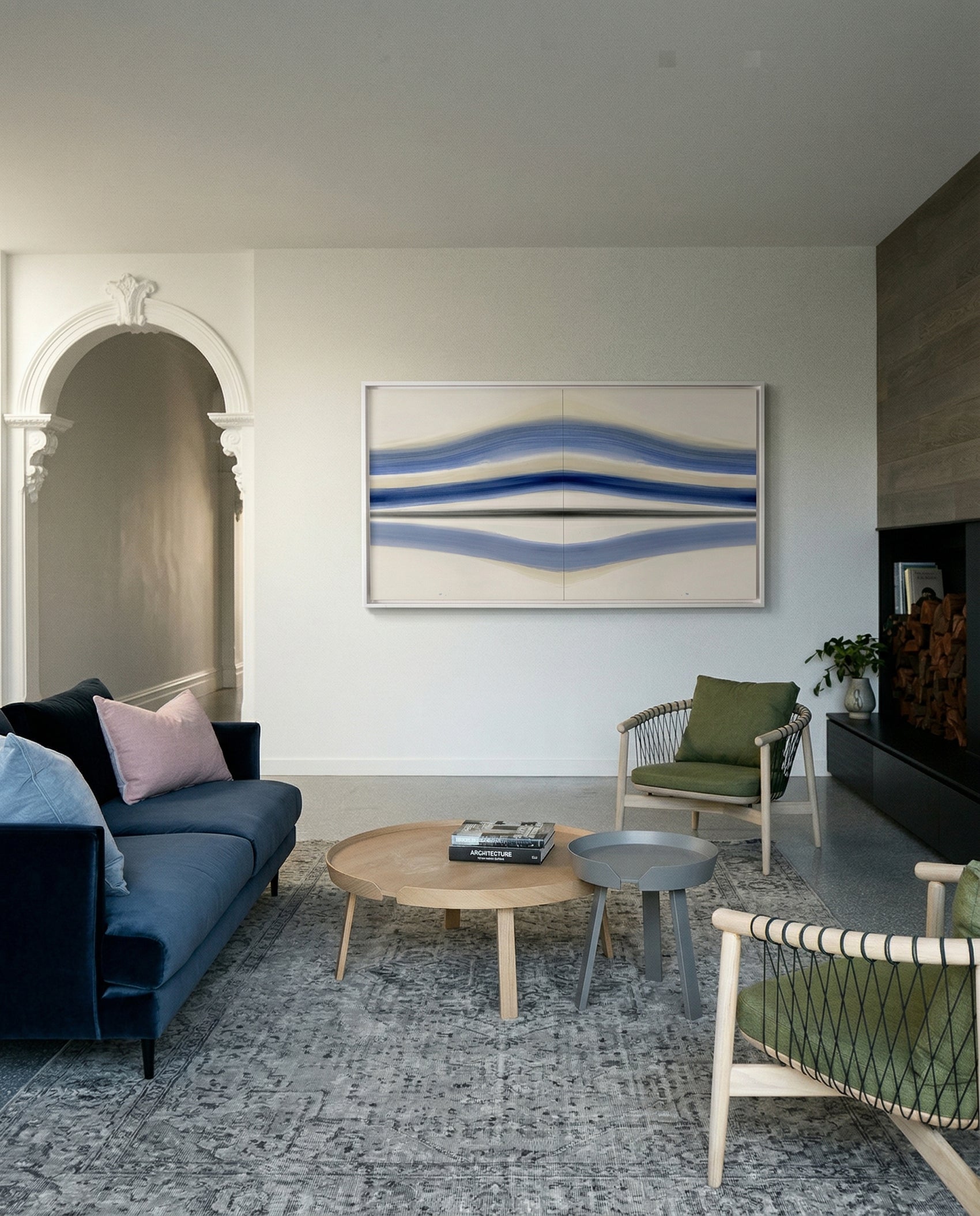 Living room with blue sofa, round wooden coffee table, and abstract art on the wall. Blue Stripes – Abstract Diptych Canvas Art | Large Luxury Wall Print | Brume Art