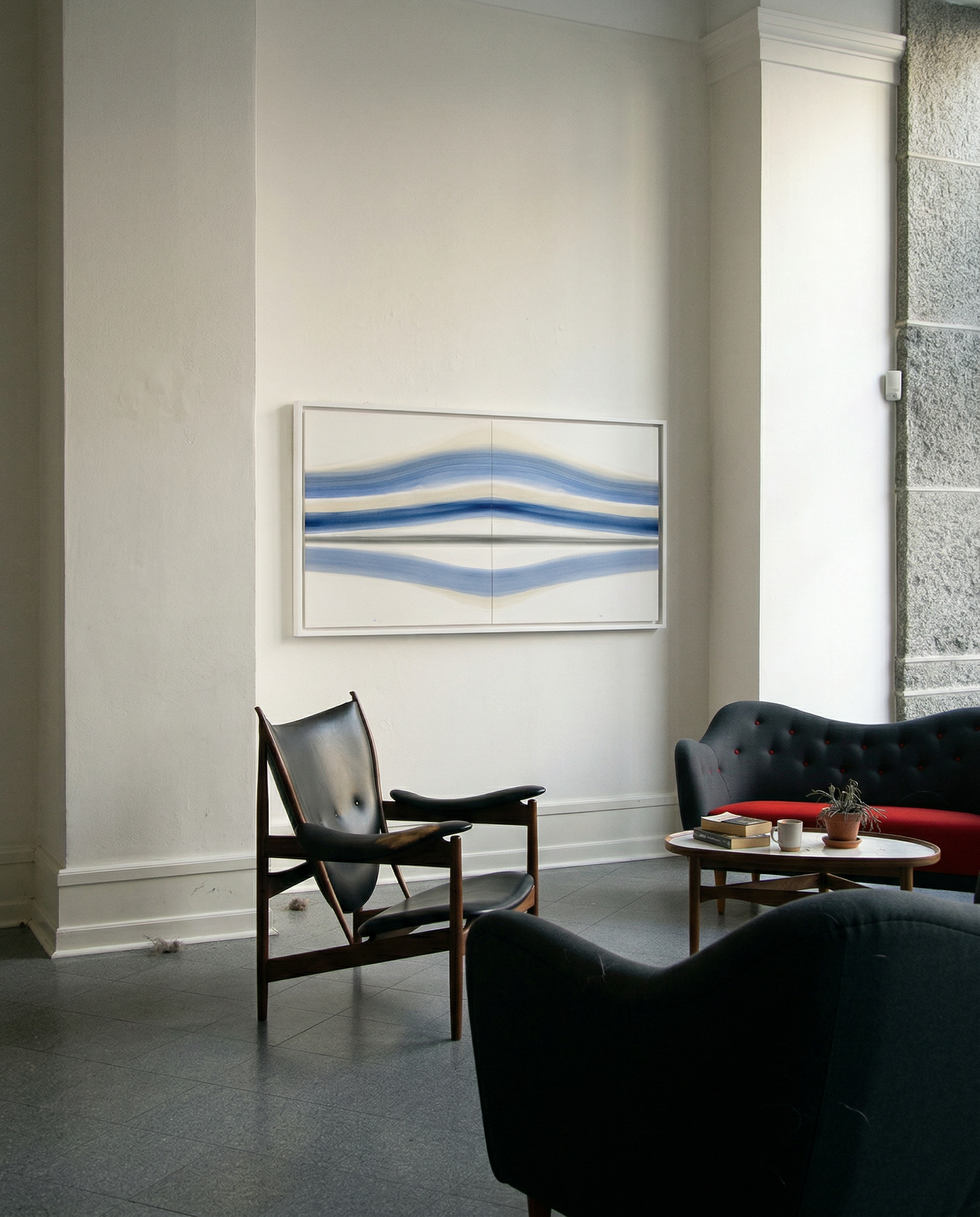 Modern living room with abstract artwork on the wall, black chairs, and a coffee table. Blue Stripes – Abstract Diptych Canvas Art | Large Luxury Wall Print | Brume Art