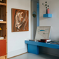 Modern interior with a blue desk, wooden bookshelf, and abstract art on the wall. Noise 4 – Textured Abstract Canvas Art | Premium Luxury Wall Decor | Brume Art | Luxury Wall Decor | Large Canvas Wall Art | Oversized Wall Hanging-Brume art
