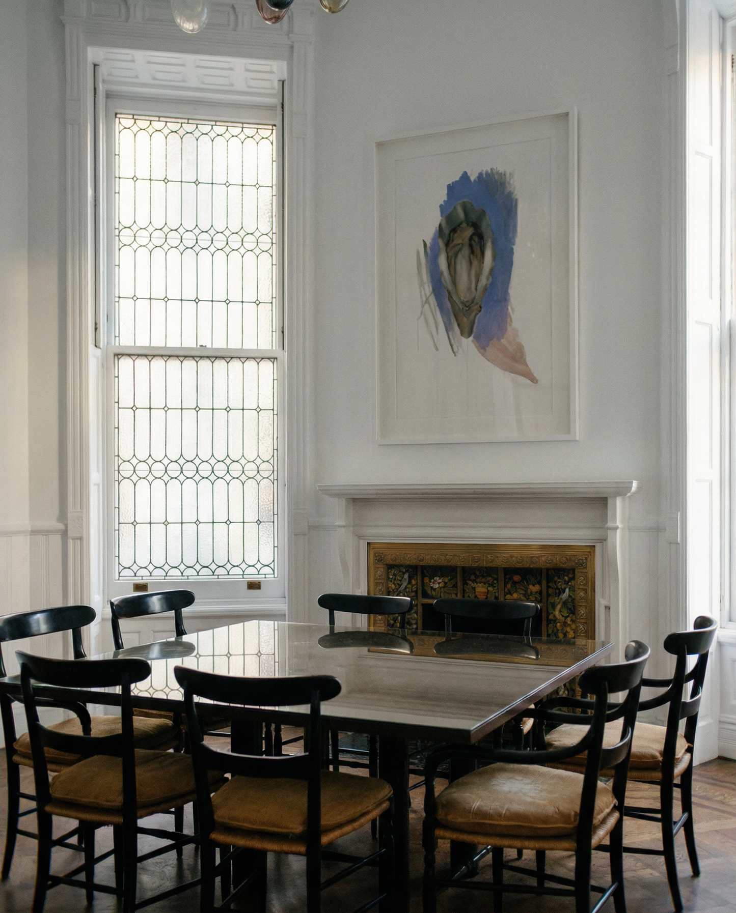 Dining room with a large table and chairs, a fireplace, and a painting on the wall. oyster – Elegant Abstract Canvas Wall Art | Luxury Giclée Print | Brume Art| Luxury Wall Decor | Large Canvas Wall Art | Oversized Wall Hanging-Brume art