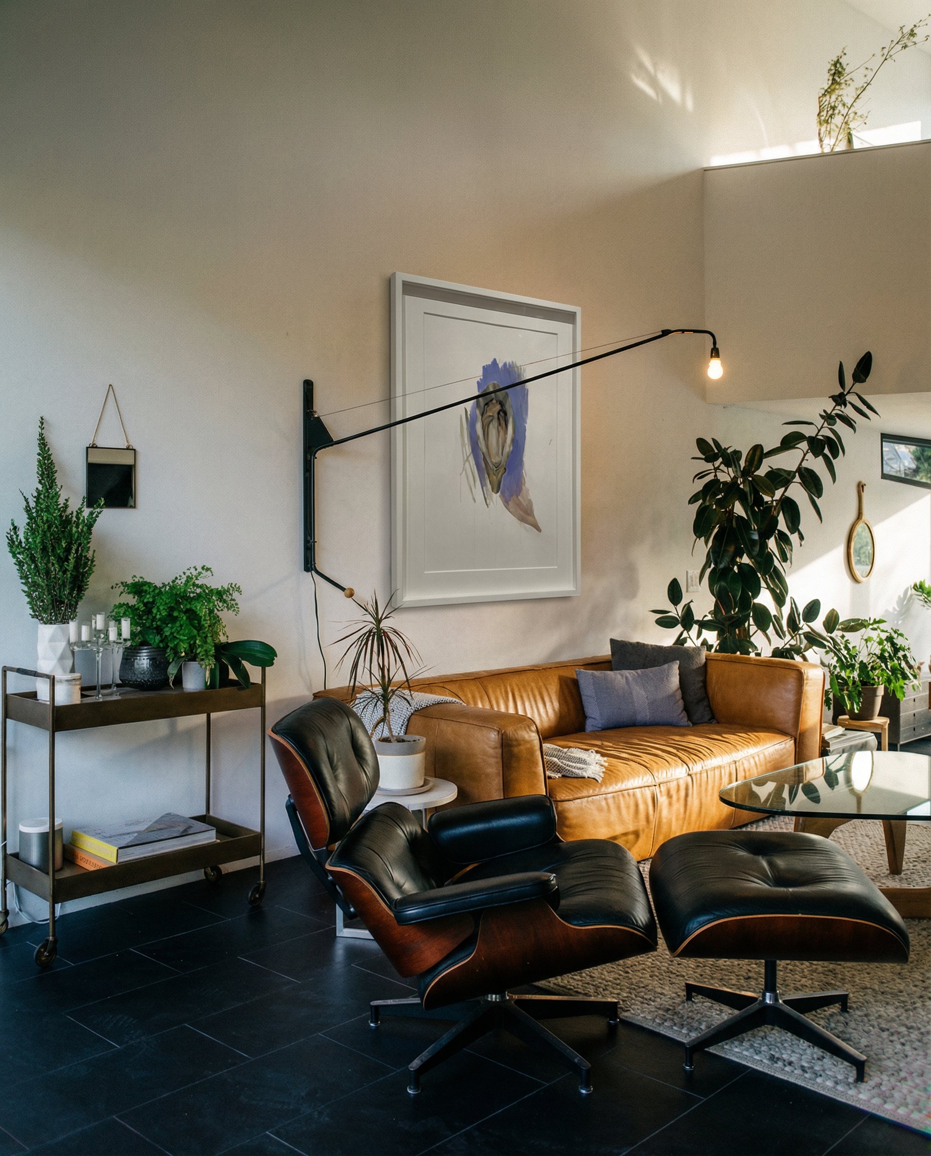 Modern living room with brown leather sofa, black armchair, and decorative plants. oyster – Elegant Abstract Canvas Wall Art | Luxury Giclée Print | Brume Art| Luxury Wall Decor | Large Canvas Wall Art | Oversized Wall Hanging-Brume art