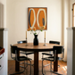 Dining room with a round wooden table and black chairs, featuring a modern abstract painting on the wall. Form - Bold Abstract Canvas Print | Large Luxury Wall Art | Brume Art | Luxury Wall Decor | Large Canvas Wall Art | Oversized Wall Hanging-Brume art