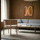 Modern living room with a gray sofa, wooden chair, and abstract art on the wall. Form - Bold Abstract Canvas Print | Large Luxury Wall Art | Brume Art | Luxury Wall Decor | Large Canvas Wall Art | Oversized Wall Hanging-Brume art