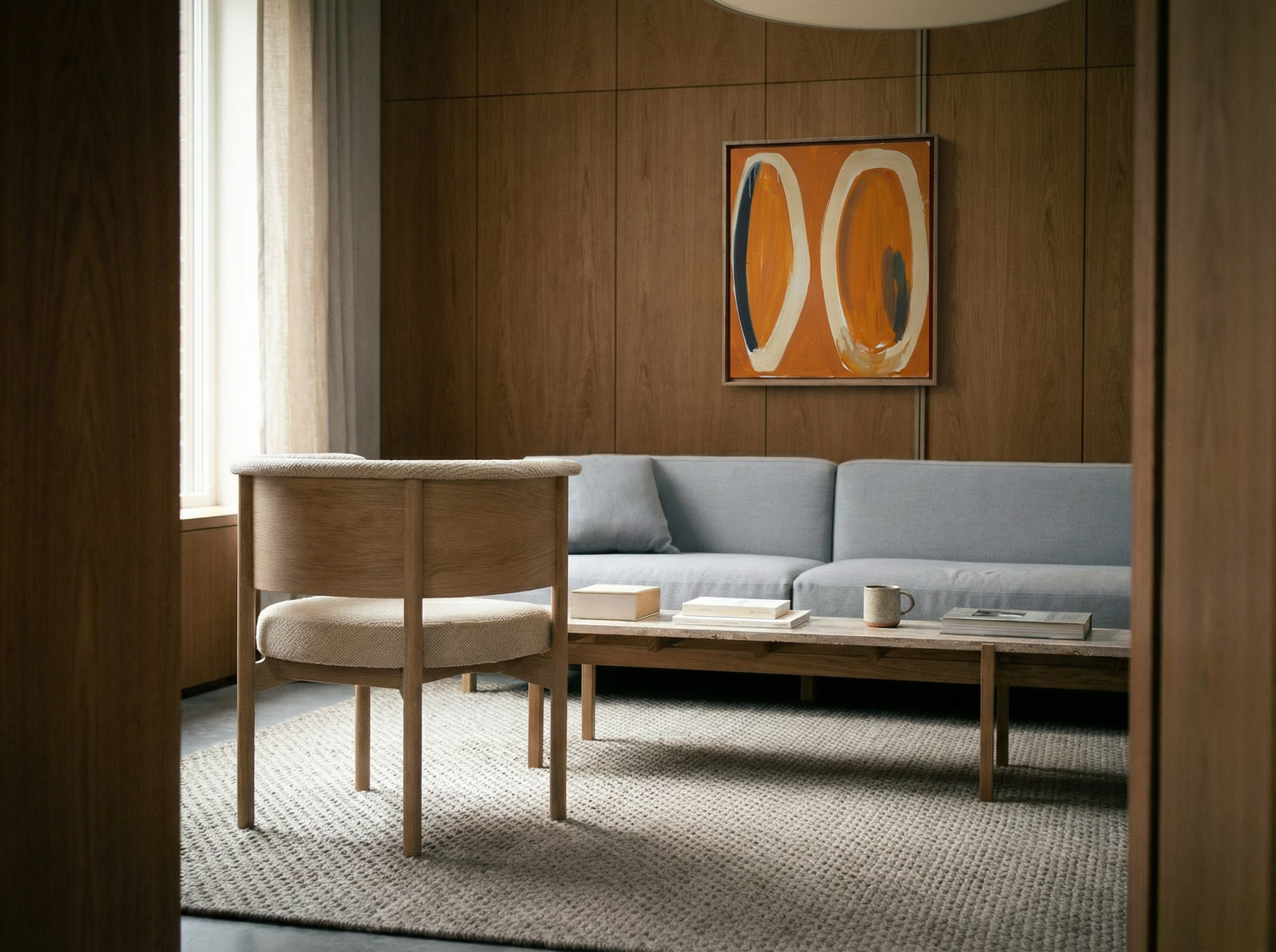 Modern living room with a gray sofa, wooden chair, and abstract art on the wall. Form - Bold Abstract Canvas Print | Large Luxury Wall Art | Brume Art | Luxury Wall Decor | Large Canvas Wall Art | Oversized Wall Hanging-Brume art