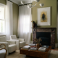 Living room with white chairs, a coffee table, and a fireplace. Fading figure – Bold Abstract Canvas Print | Large Luxury Wall Art | Brume Art