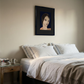 Bedroom with a bed, nightstand, and framed portrait on the wall. lady boss – Figurative Canvas Print | Modern Luxury Wall Art | Brume Art | Luxury Wall Decor | Large Canvas Wall Art | Oversized Wall Hanging-Brume art