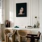Modern interior with beige chairs, a dark wooden chair, and a framed portrait on a white wall. lady boss – Figurative Canvas Print | Modern Luxury Wall Art | Brume Art | Luxury Wall Decor | Large Canvas Wall Art | Oversized Wall Hanging-Brume art