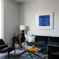 Modern living room with a black sofa, coffee table, and wall art. Presence 4 – Figurative Abstract Canvas Print | Large Luxury Wall Art | Brume Art
