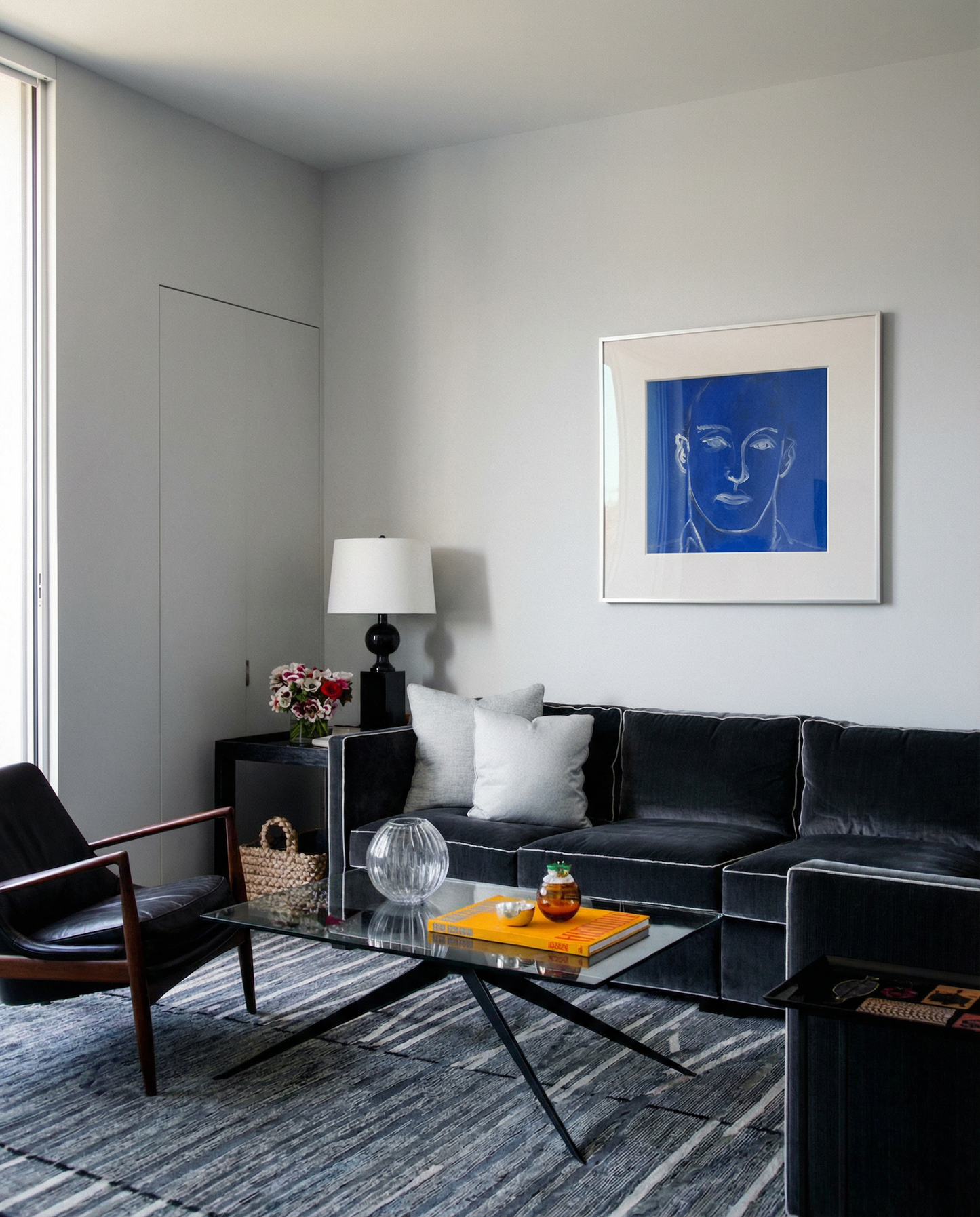 Modern living room with a black sofa, coffee table, and wall art. Presence 4 – Figurative Abstract Canvas Print | Large Luxury Wall Art | Brume Art