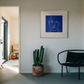 Modern interior with a black chair, cactus plant, and framed artwork on a white wall. Presence 4 – Figurative Abstract Canvas Print | Large Luxury Wall Art | Brume Art