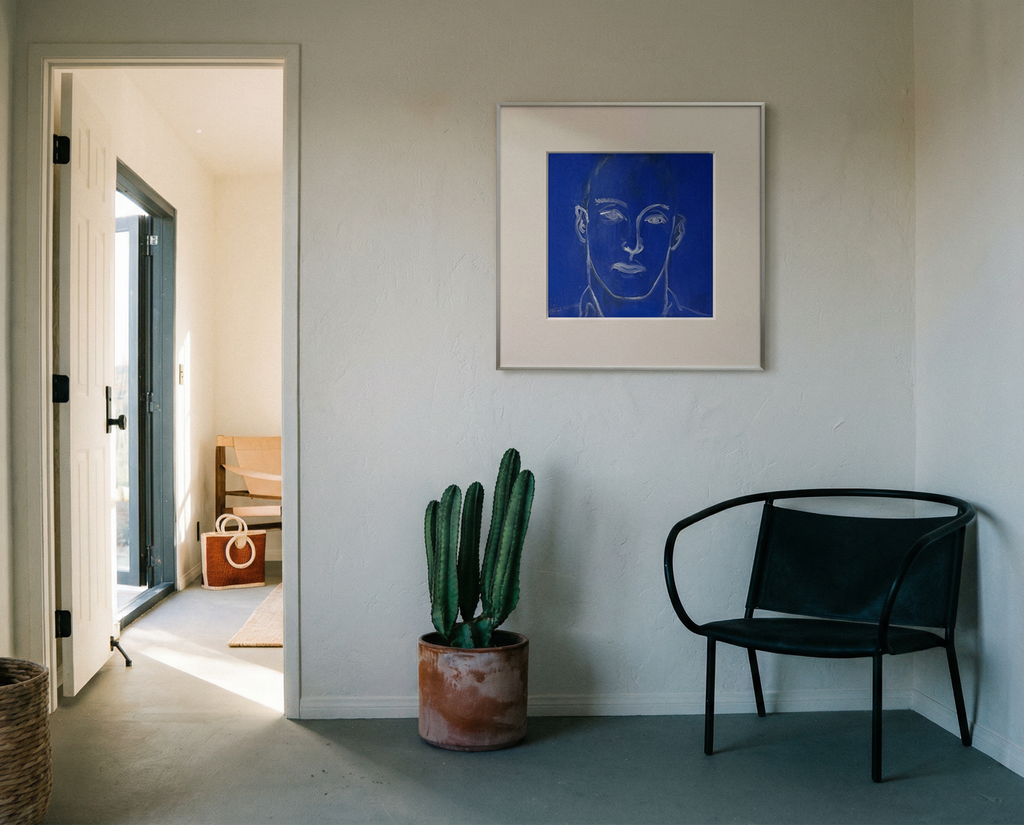 Modern interior with a black chair, cactus plant, and framed artwork on a white wall. Presence 4 – Figurative Abstract Canvas Print | Large Luxury Wall Art | Brume Art