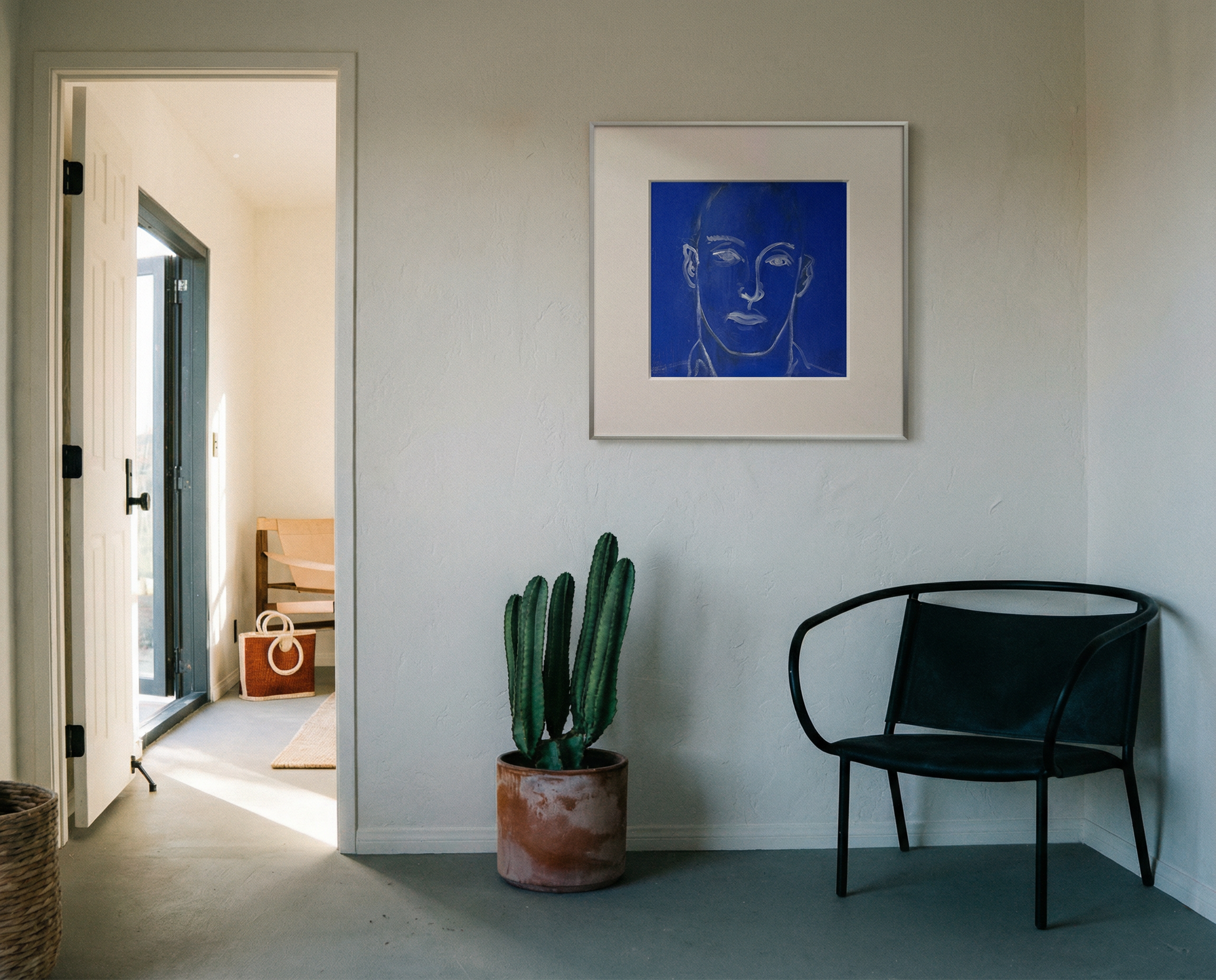 Modern interior with a black chair, cactus plant, and framed artwork on a white wall. Presence 4 – Figurative Abstract Canvas Print | Large Luxury Wall Art | Brume Art