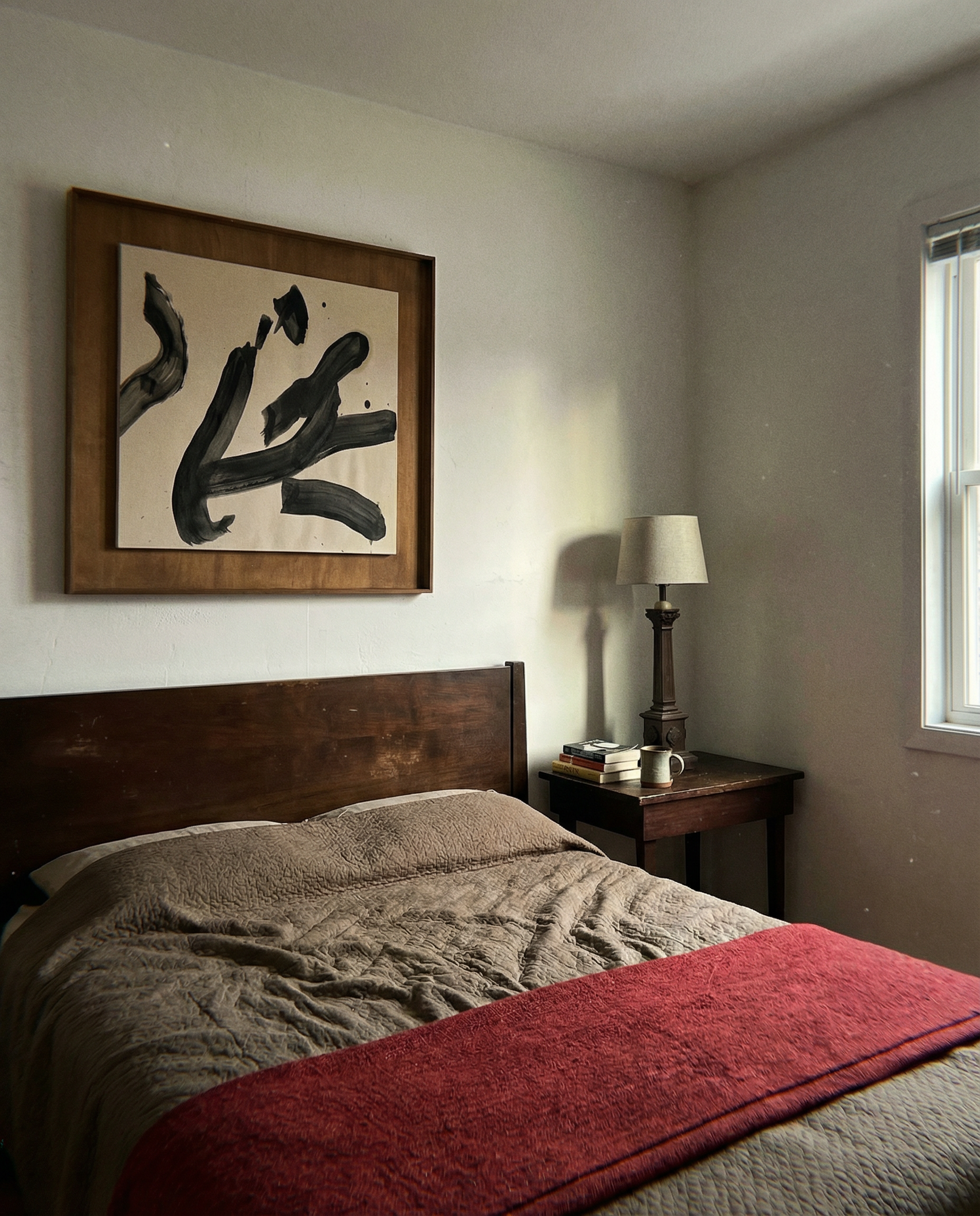 Bedroom with wooden headboard, red blanket, and framed artwork on wall. Ink 3 – Abstract Ink Canvas Wall Art | Oversized Luxury Print | Brume Art | Luxury Wall Decor | Large Canvas Wall Art | Oversized Wall Hanging-Brume art