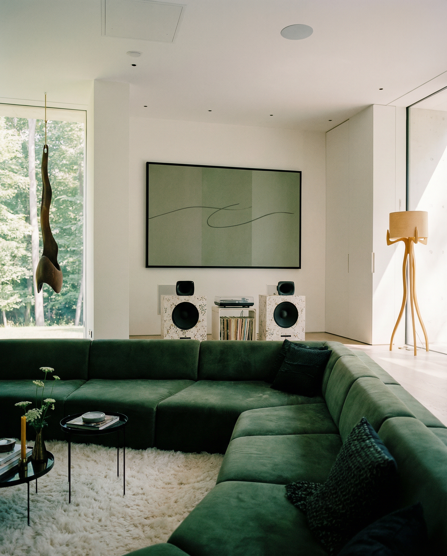 Modern living room with a green sectional sofa, wall-mounted TV, and decorative elements. olive – Bold Abstract Canvas Print | Large Luxury Wall Art | Brume Art