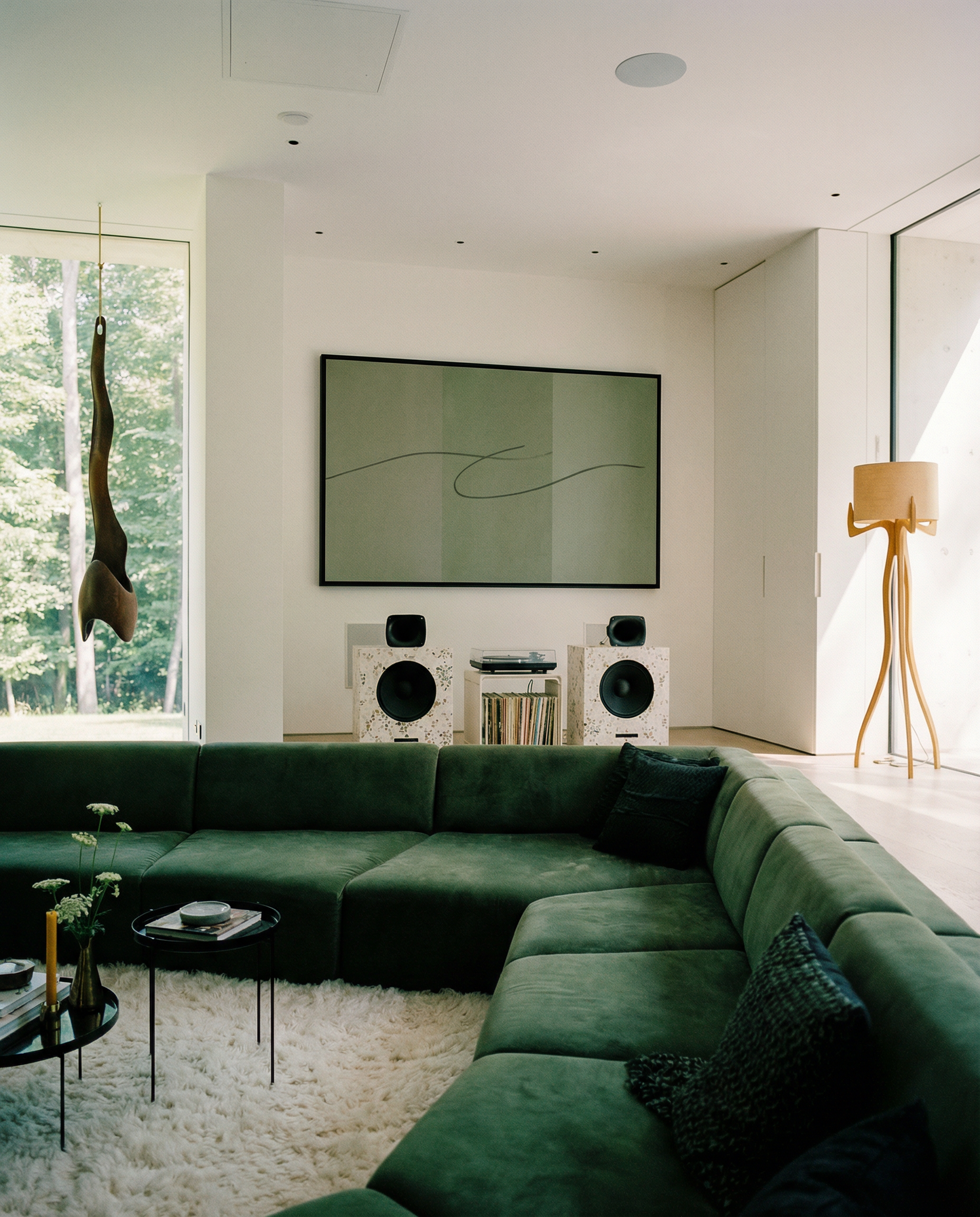 Modern living room with a green sectional sofa, wall-mounted TV, and decorative elements. olive – Bold Abstract Canvas Print | Large Luxury Wall Art | Brume Art