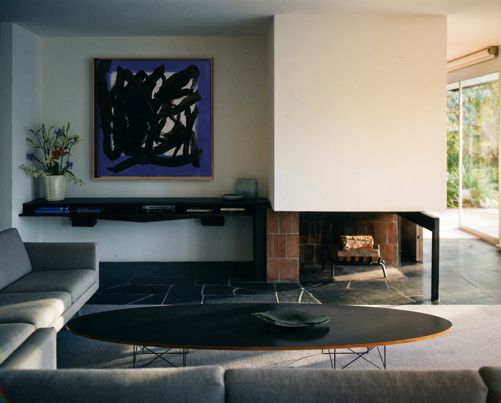 Modern living room with abstract painting, gray sofa, and oval coffee table. Noise 5 – Bold Abstract Canvas Print | Large Luxury Wall Art | Brume Art