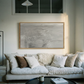 Living room with a beige sofa, decorative pillows, and framed artwork on the wall. Fade – Bold Abstract Canvas Wall Art | Large Luxury Print | Brume Art