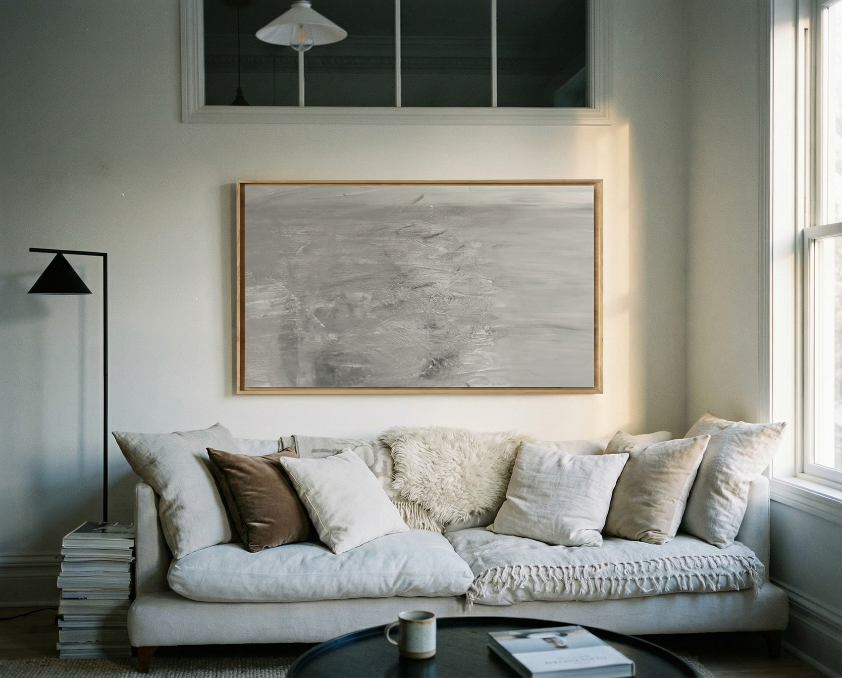 Living room with a beige sofa, decorative pillows, and framed artwork on the wall. Fade – Bold Abstract Canvas Wall Art | Large Luxury Print | Brume Art