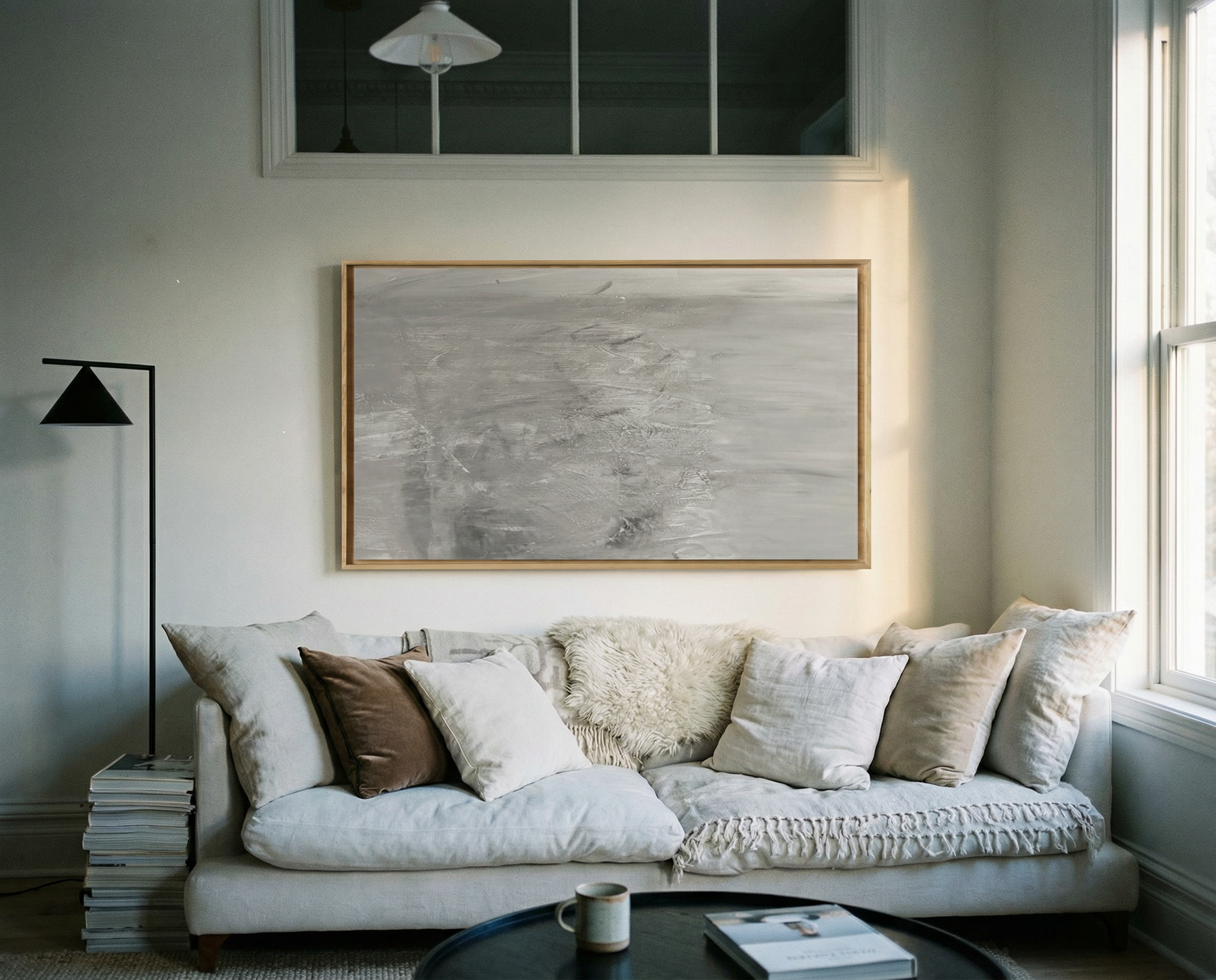 Living room with a beige sofa, decorative pillows, and framed artwork on the wall. Fade – Bold Abstract Canvas Wall Art | Large Luxury Print | Brume Art