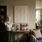 Living room with classical bust, framed artwork, and decorative items on a table. Reach – Figurative Abstract Canvas Print | Premium Wall Art | Brume Art