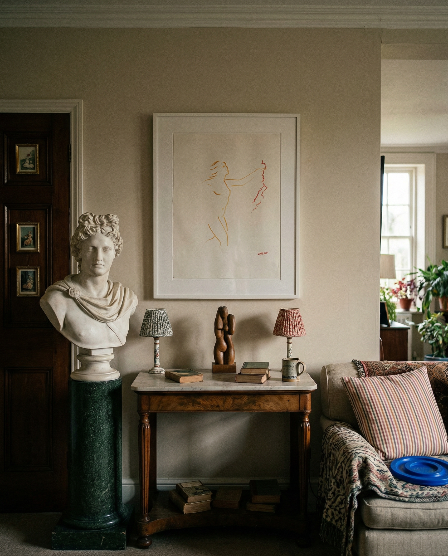 Living room with classical bust, framed artwork, and decorative items on a table. Reach – Figurative Abstract Canvas Print | Premium Wall Art | Brume Art
