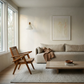 Modern living room with a wooden armchair, sofa, and coffee table. Reach – Figurative Abstract Canvas Print | Premium Wall Art | Brume Art