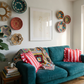 Living room with teal sofa, colorful pillows, and decorative plates on the wall. Reach – Figurative Abstract Canvas Print | Premium Wall Art | Brume Art