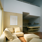 Modern living room with beige sectional sofa and ottomans, wooden floor, and wall art. Reach – Figurative Abstract Canvas Print | Premium Wall Art | Brume Art