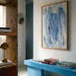 Modern interior with a blue bench, abstract painting, and wooden shelf. Veil – Contemporary Abstract Canvas | Oversized Luxury Wall Art | Brume Art | Luxury Wall Decor | Large Canvas Wall Art | Oversized Wall Hanging-Brume art
